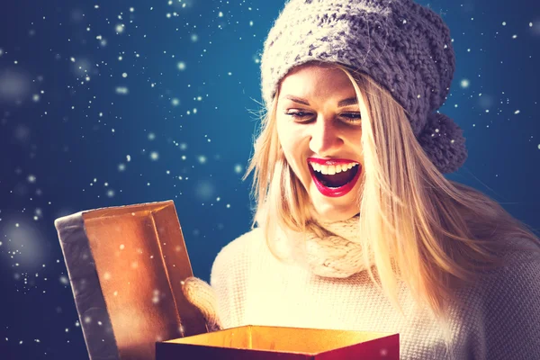 Young woman opening Christmas box — Stock Photo, Image