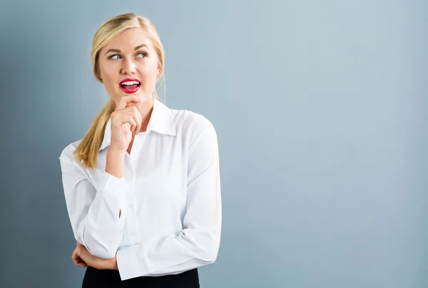 Young businesswoman in thoughtful pose — Stock Photo, Image