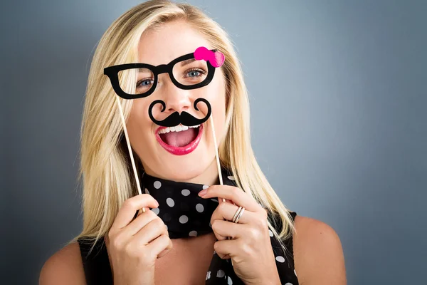 Woman holding paper party sticks — Stock Photo, Image