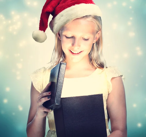 Girl in Santa Hat opening box — Stock Photo, Image