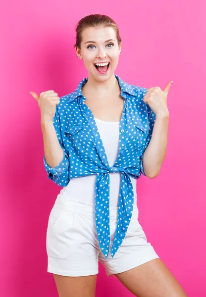 Happy young woman giving thumbs up — Stock Photo, Image