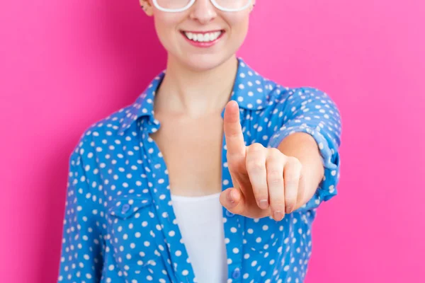 Happy young woman pointing — Stock Photo, Image