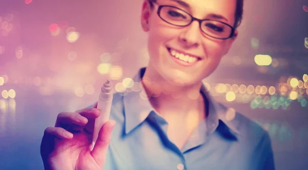 Joven mujer profesional en gafas escribiendo algo — Foto de Stock