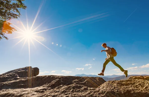 Ο άνθρωπος άλματα πάνω από το χάσμα στην ορεινή πεζοπορία — Φωτογραφία Αρχείου
