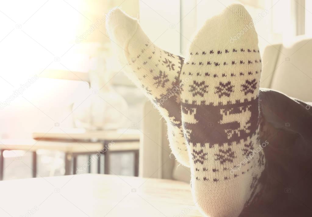 Person relaxing in Christmas themed socks