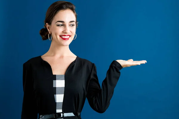 Young woman with a displaying hand gesture — Stock Photo, Image