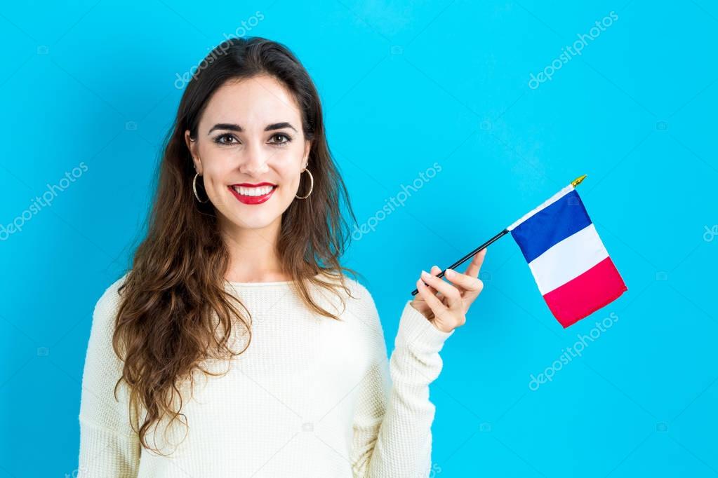 Young woman holding French flag