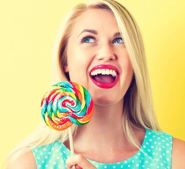 Young woman holding a lollipop — Stock Photo, Image