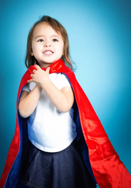 Menina criança feliz em uma capa de super herói — Fotografia de Stock