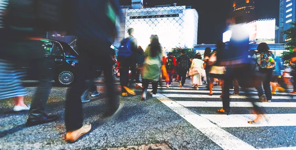 Motion blurred people walking at night — Stock Photo, Image