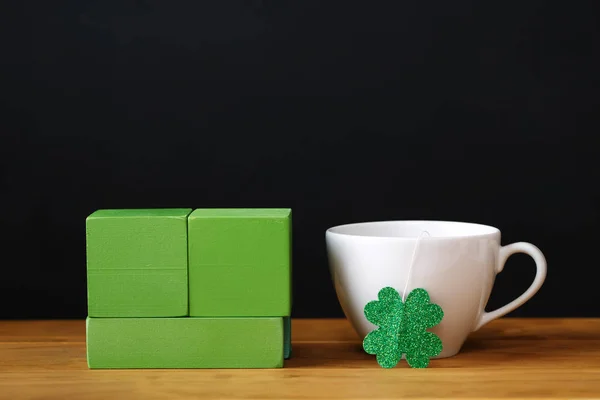 Green clover with white coffee cup — Stock Photo, Image