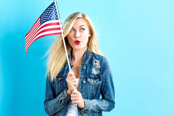 Young woman holding American flag