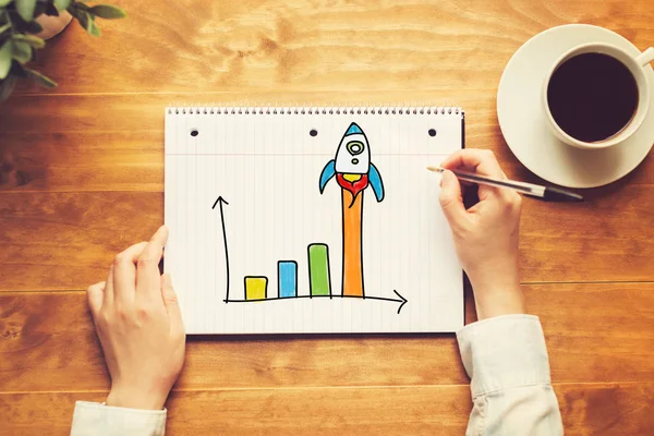 Rocket Graph with person holding pen — Stock Photo, Image