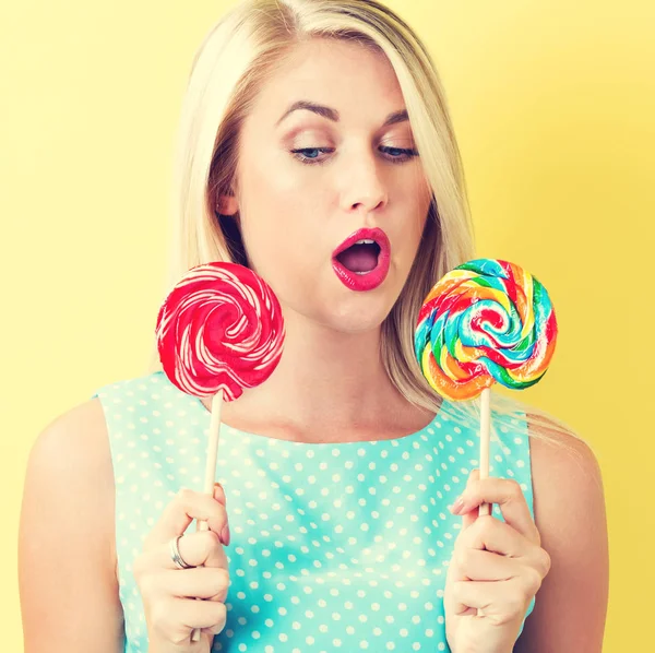 Woman holding lollipops — Stock Photo, Image