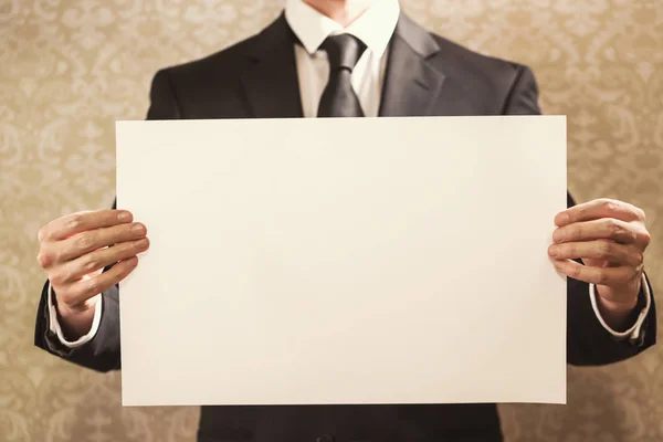 Businessman holding sign board