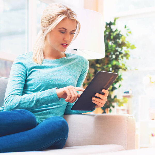 young woman using digital tablet