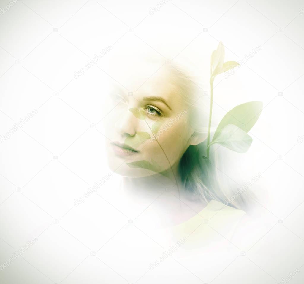 Double exposure of young woman and plants