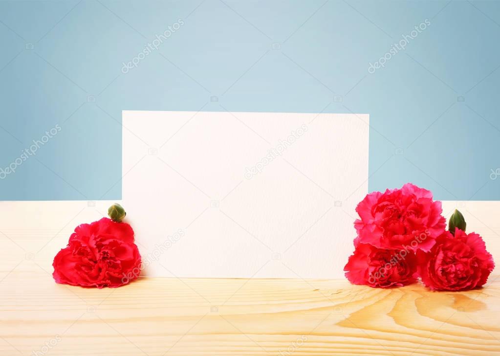 Blank Greeting Card with Carnation Flowers on the Table