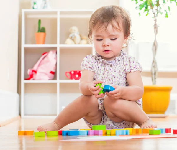 Menina brincando com seus brinquedos — Fotografia de Stock