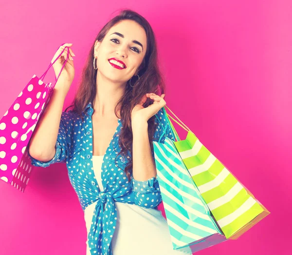 Mulher segurando muitos sacos de compras — Fotografia de Stock