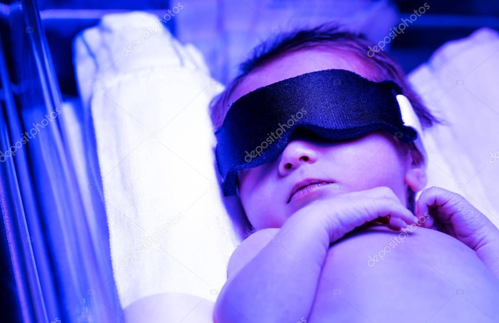 Newborn baby receiving phototherapy 