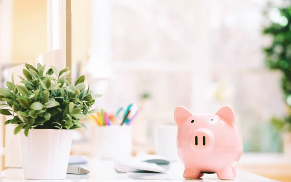Pink piggy bank on a desk — Stock Photo, Image