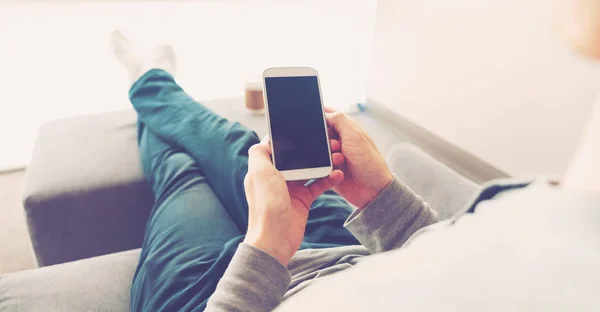 Person relaxing and using smart phone — Stock Photo, Image