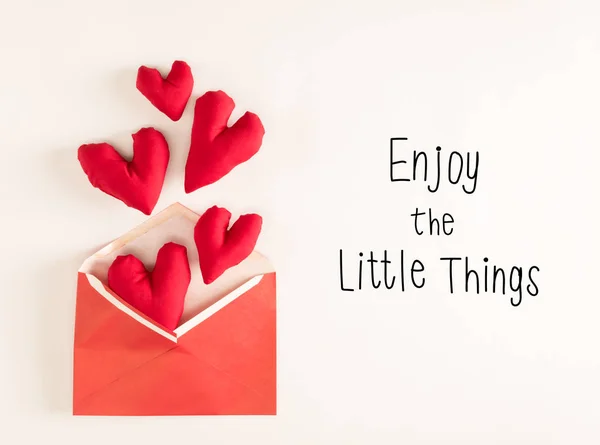 Enjoy The Little Things message with red heart cushions — Stock Photo, Image