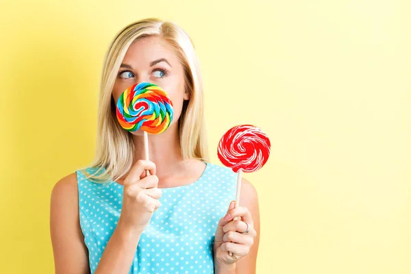 Young woman holding lollipops — Stock Photo, Image