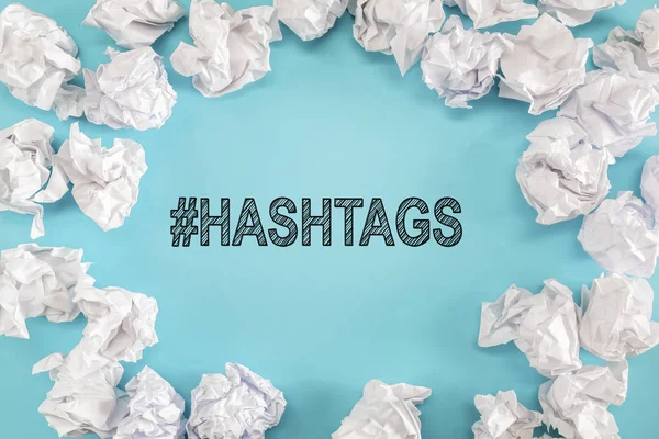 Hashtags text with crumpled paper balls — Stock Photo, Image