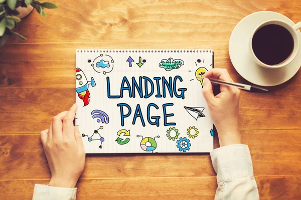 Landing Page text with a person holding a pen — Stock Photo, Image