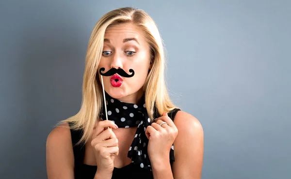 Young woman holding paper party sticks — Stock Photo, Image