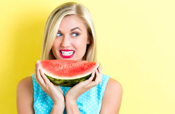 Happy young woman holding watermelon — Stock Photo, Image