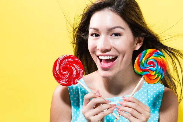 Young woman holding lollipops — Stock Photo, Image