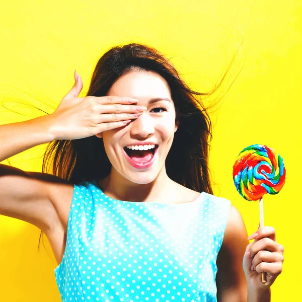 Young woman holding a lollipop — Stock Photo, Image