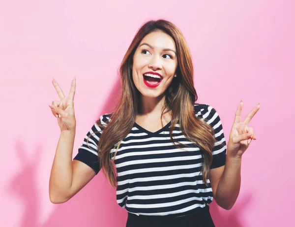 Junge Frau gibt das Friedenszeichen — Stockfoto