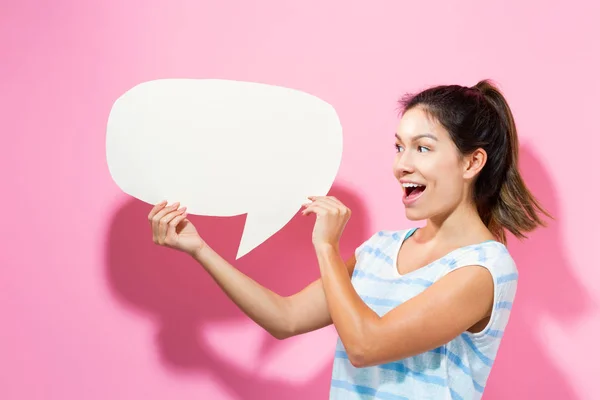 Young woman holding a speech bubble