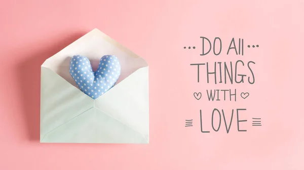 Do All Things With Love message with a blue heart cushion — Stock Photo, Image