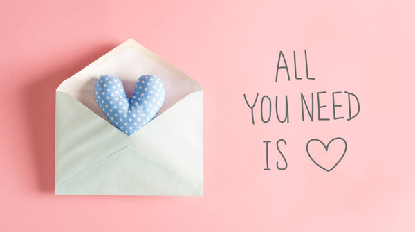 All You Need Is Love message with a blue heart cushion