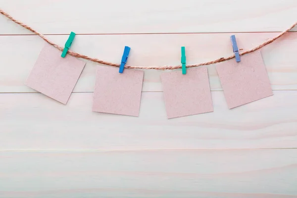 Small cards hanging with clothespins — Stock Photo, Image