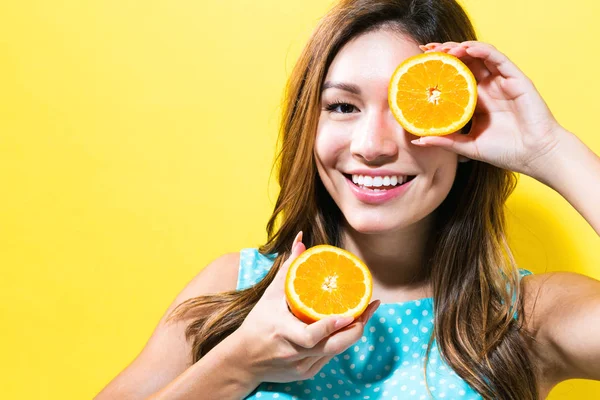 Happy young woman holding oranges Royalty Free Stock Photos