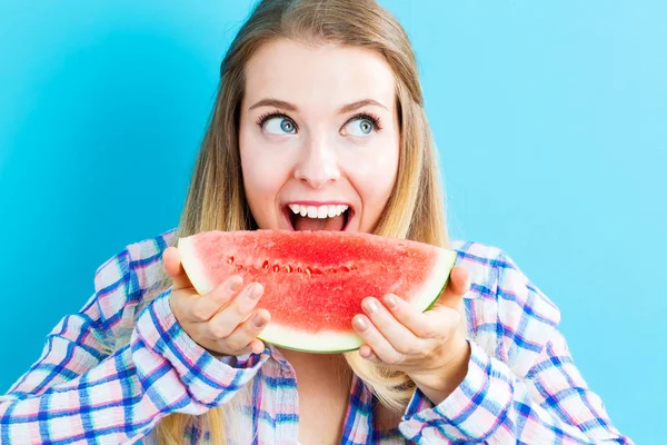 Happy young woman holding watermelon — Stock Photo, Image