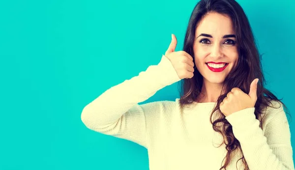 Happy young woman giving thumbs up — Stock Photo, Image