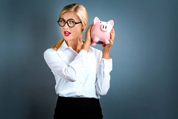 Young woman with a piggy bank — Stock Photo, Image