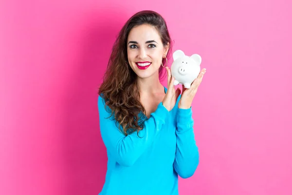 Young woman with a piggy bank — Stock Photo, Image