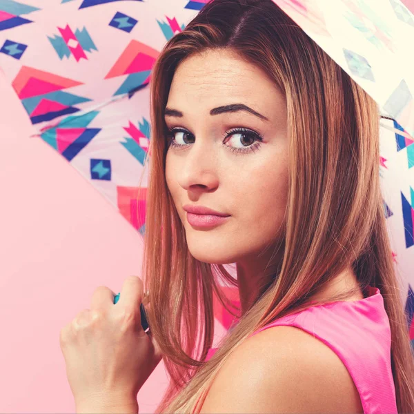 Happy young woman holding an umbrella — Stock Photo, Image