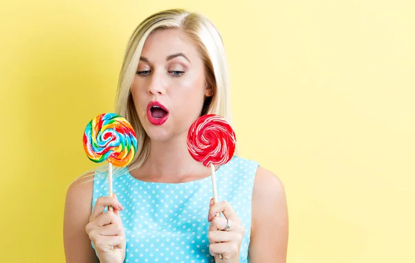 Young woman holding lollipops — Stock Photo, Image