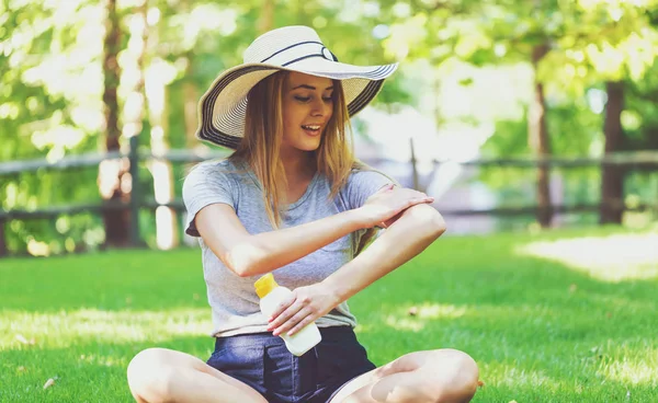 Woman with bottle of sunblock — Stock Photo, Image