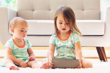 Bir tablet izlerken yürümeye başlayan çocuk kız 