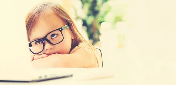 Little girl with her laptop computer — Stock Photo, Image